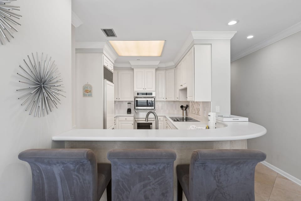 Well equipped kitchen with conventional/convection oven, microwave, and a warming oven & electric cooktop.