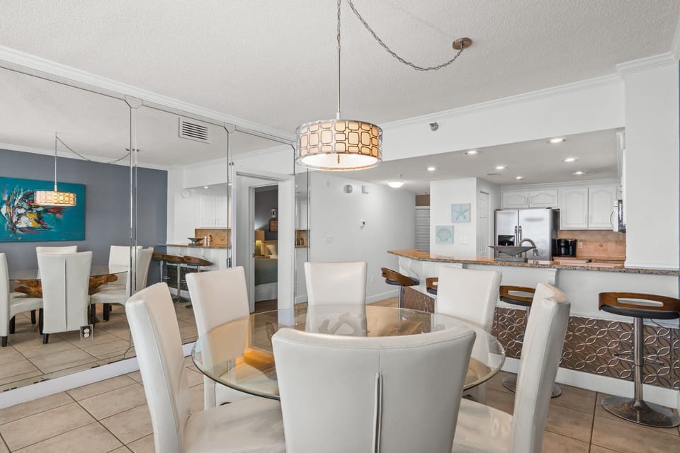 Elegant dining space for 6; room for more at kitchen bar - and on the balcony.