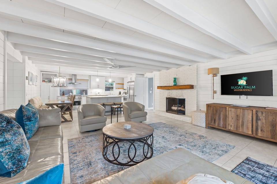 Plenty of seating in living room with fireplace & large Smart TV