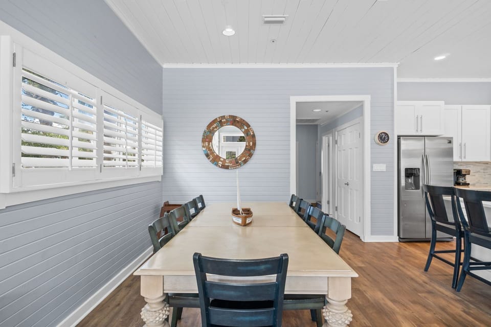 Large dining table seats up to 12 plus seating for more at the kitchen island.