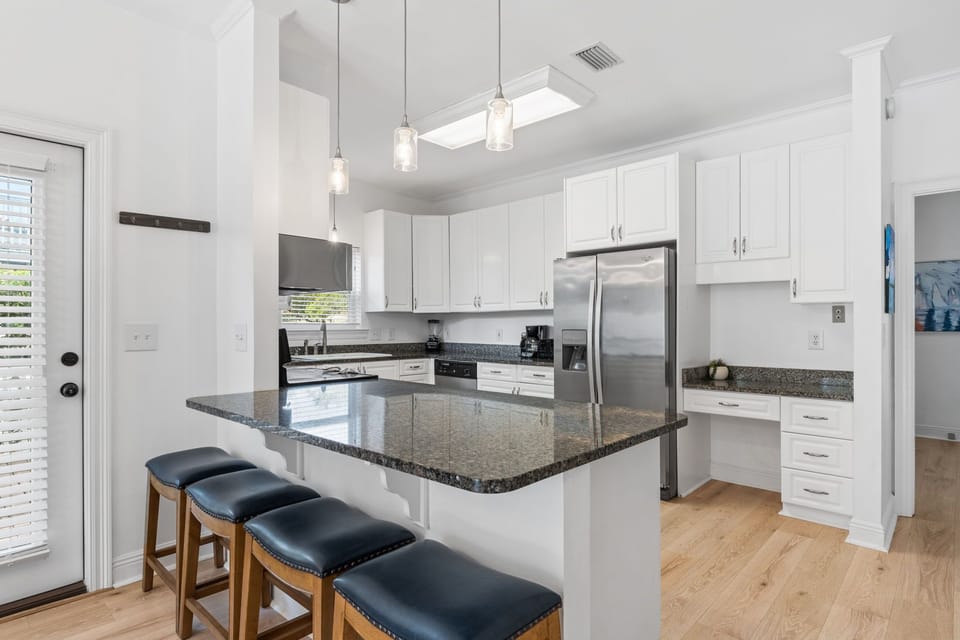 Well equipped open kitchen with island seating.