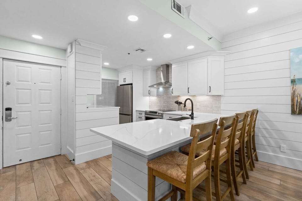 Fully remodeled kitchen featuring white cabinetry, stainless steel appliances, farmhouse sink, and an open layout perfect for cooking and entertaining.
