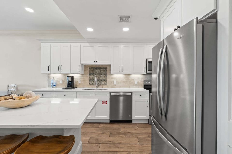 Clean, modern kitchen workspace with double sink, coffee station, and plenty of counter space for meal prep.