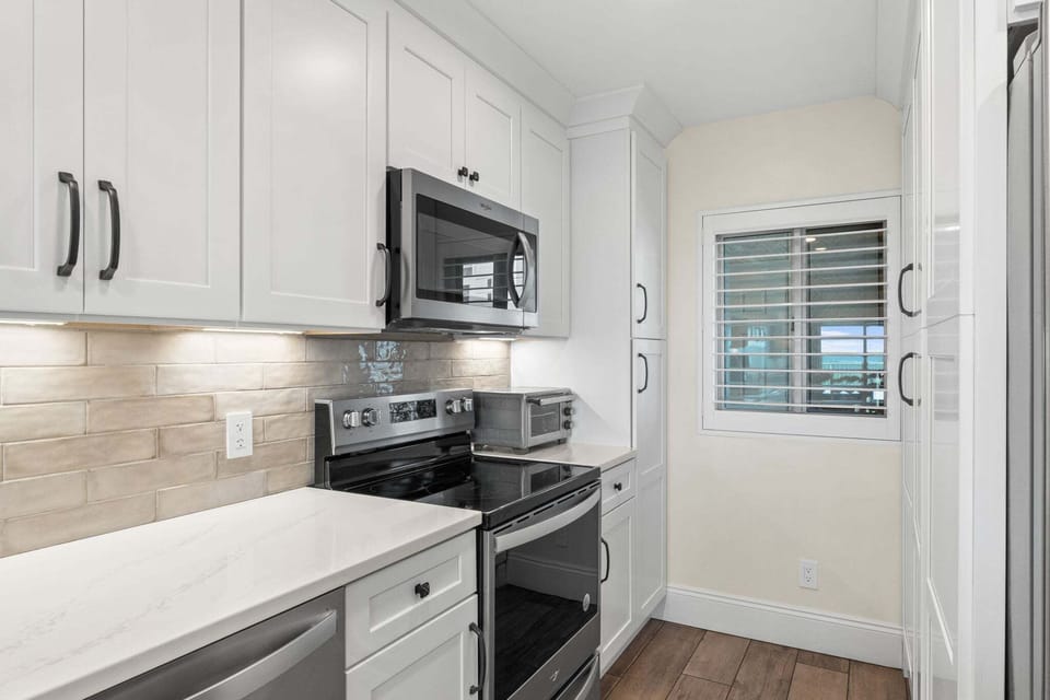 Clean, modern kitchen workspace with double sink, coffee station, and plenty of counter space for meal prep.
