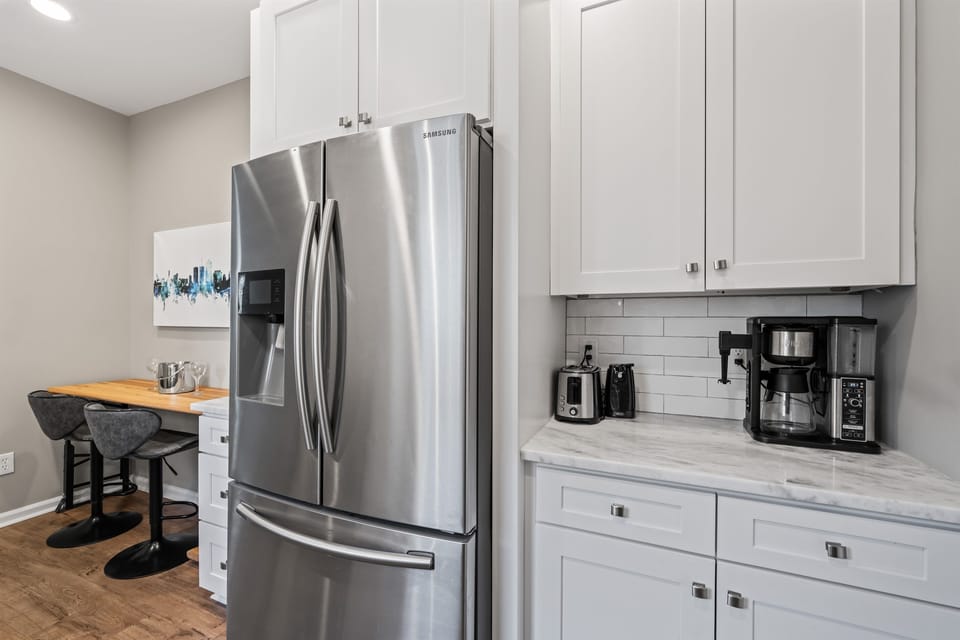 Full-size stainless steel fridge and fully equipped kitchen