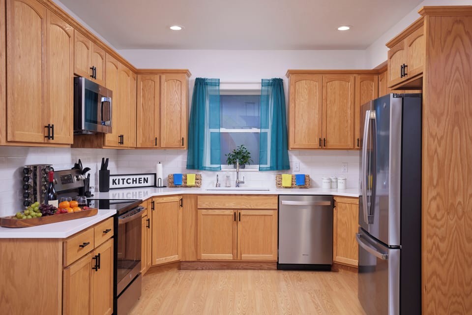 Bright full kitchen with stainless appliances and ample prep space