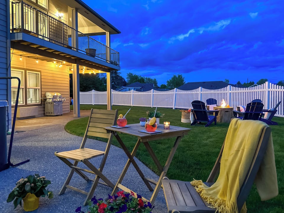 Private backyard with hot tub, patio seating & evening ambiance