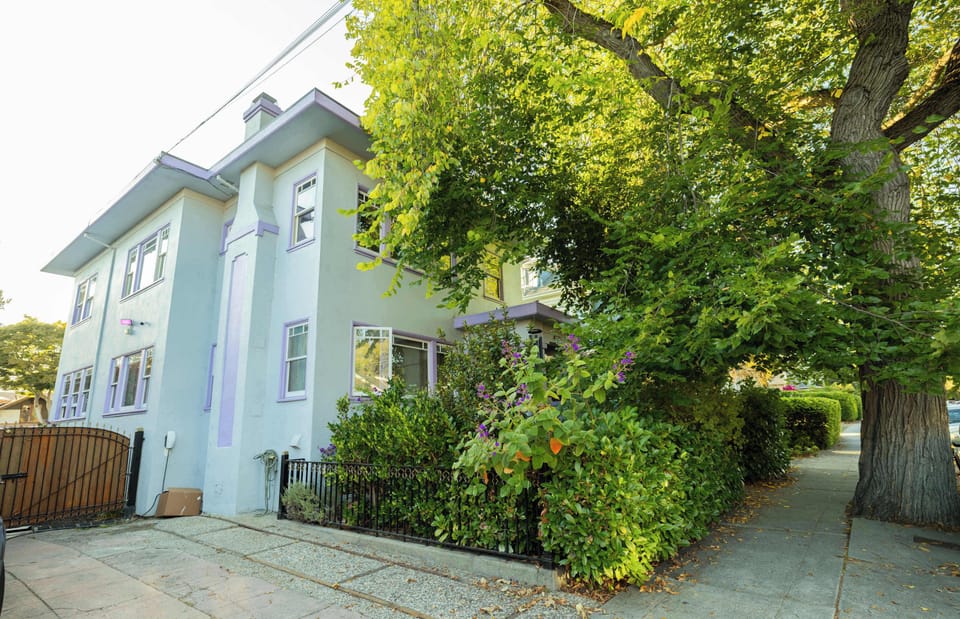 Surrounded by mature trees and vibrant greenery, the home offers a peaceful, private setting in a beautiful neighborhood