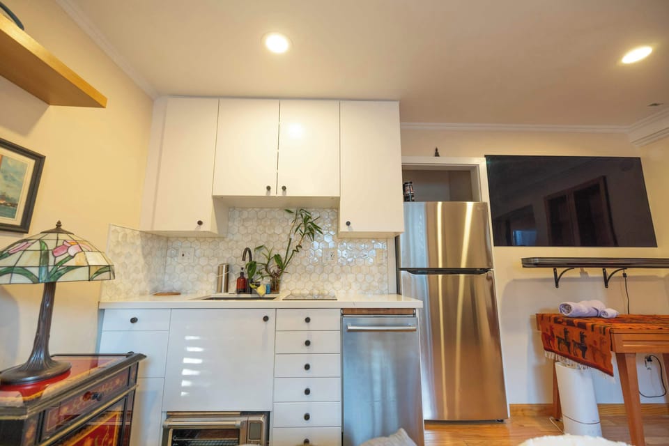 The master bedroom features a convenient kitchenette with sink, fridge, and essentials—perfect for added comfort and flexibility during your stay