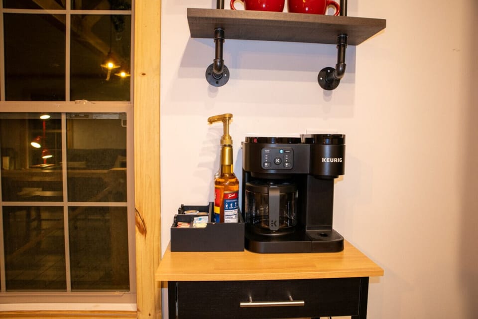 Coffee station with Keurig maker, coffee pods, and supplies for the perfect morning at the cabin.