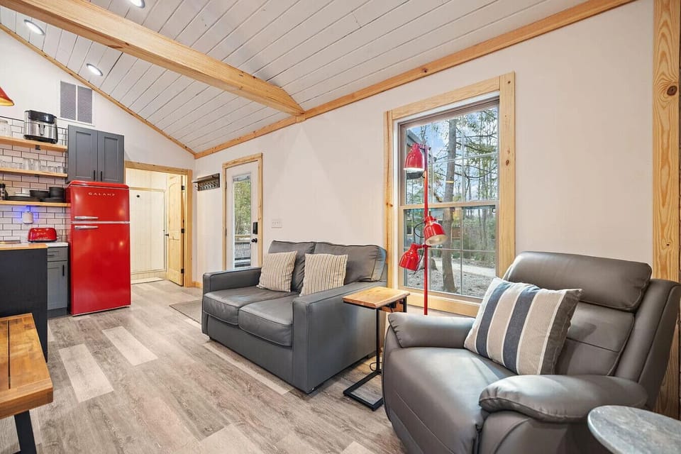 Cozy living area with comfortable seating, large windows, and open access to the modern kitchen.