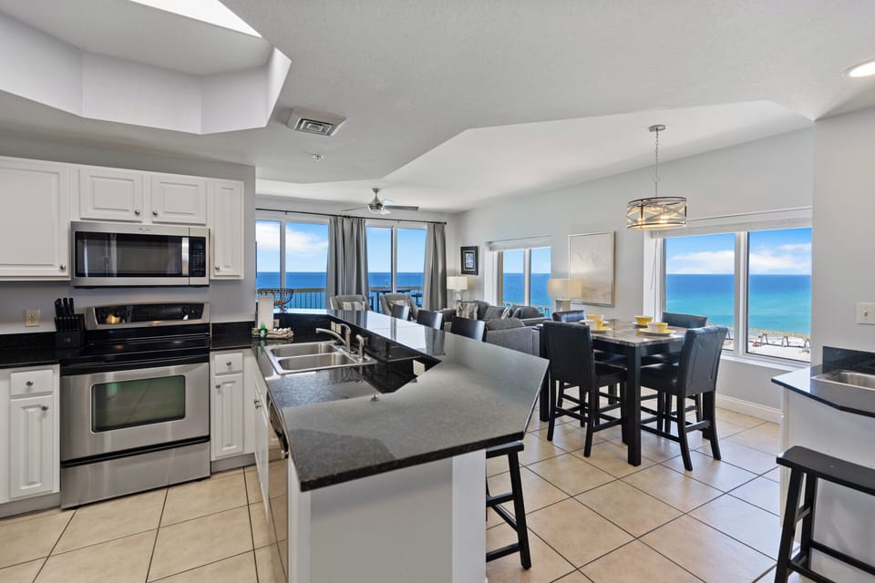 Your modern kitchen opens to stunning ocean views, where you'll cook with endless blue horizons as your backdrop through floor-to-ceiling windows.