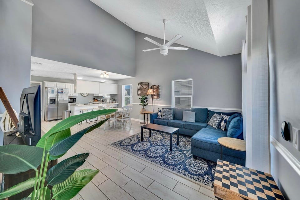 Walk in to the open concept living area with plush furnishings and TV