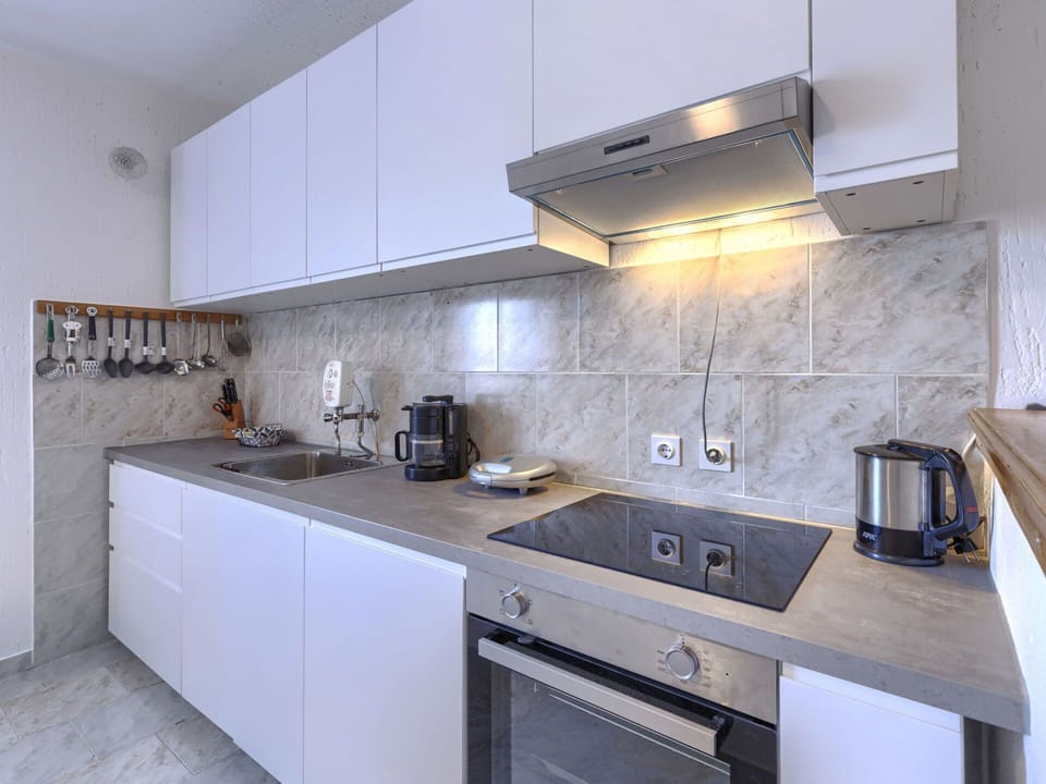 Kitchen Appliance, Kitchen, Countertop, Major Appliance, Cabinetry, Home Appliance, Kitchen Stove, Flooring, Kitchen Sink, Interior Design