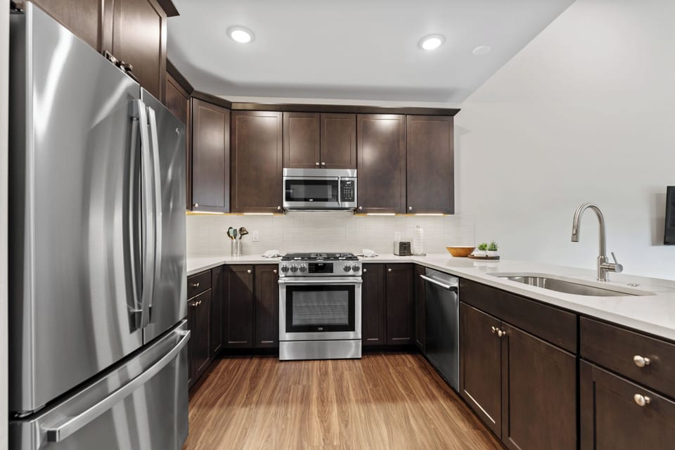 Your fully equipped kitchen features sleek stainless steel appliances, rich wood cabinets, and pristine countertops for culinary adventures.