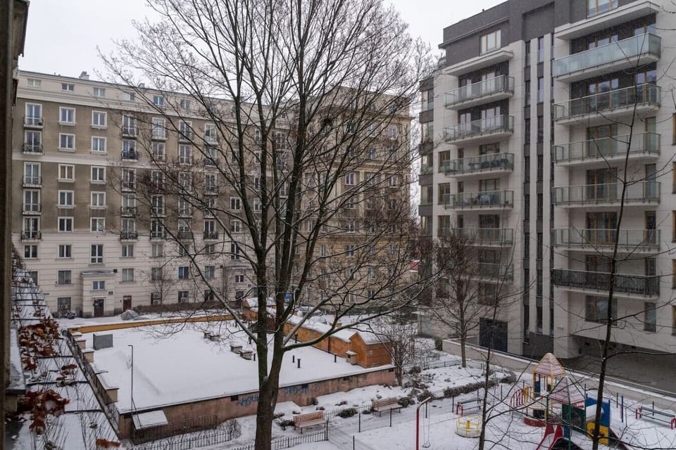 Balcony View – Overlooking a Quiet Courtyard with Playground and Surrounding Greenery | Book Now with RENTUJEMY.COM