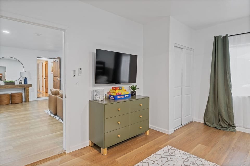 50 inch TV, board games and dresser in bunk. room
