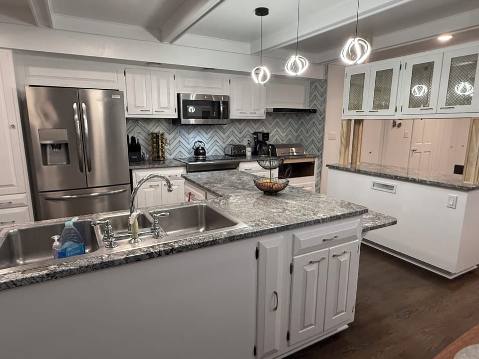 Fully renovated and stocked gourmet chef kitchen with island and ample seating!