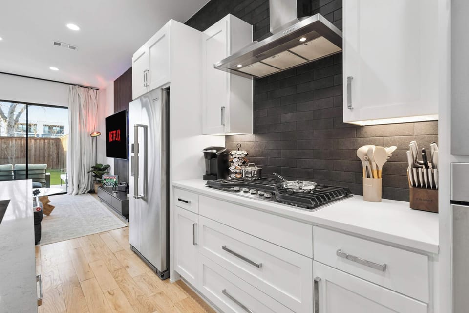 Cook with ease in a fully equipped kitchen featuring modern appliances and generous counter space. Whether it is takeout or a full dinner spread, everything you need is within reach.