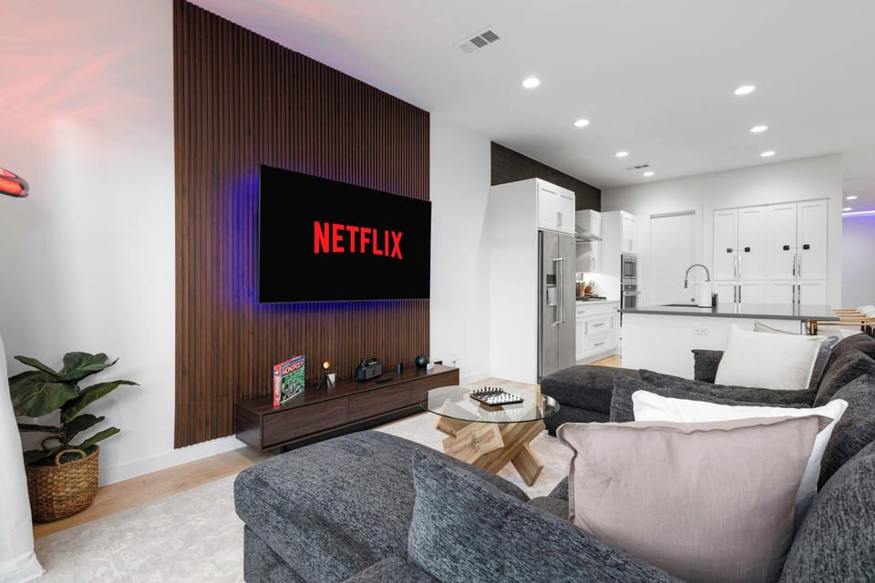 Enjoy a premium entertainment setup with comfortable lounge seating and a sleek TV feature wall. Ideal for relaxing evenings, binge watching your favorite shows, or game night fun.