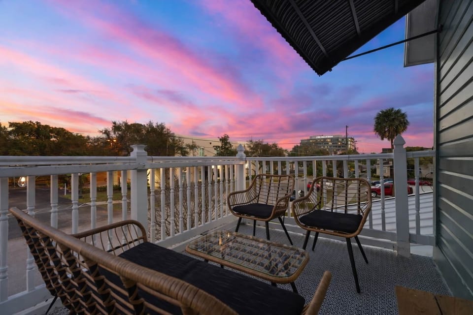 Private balcony with sunset views and outdoor seating at the Sunlit Sanctuary in Hyde Park Tampa