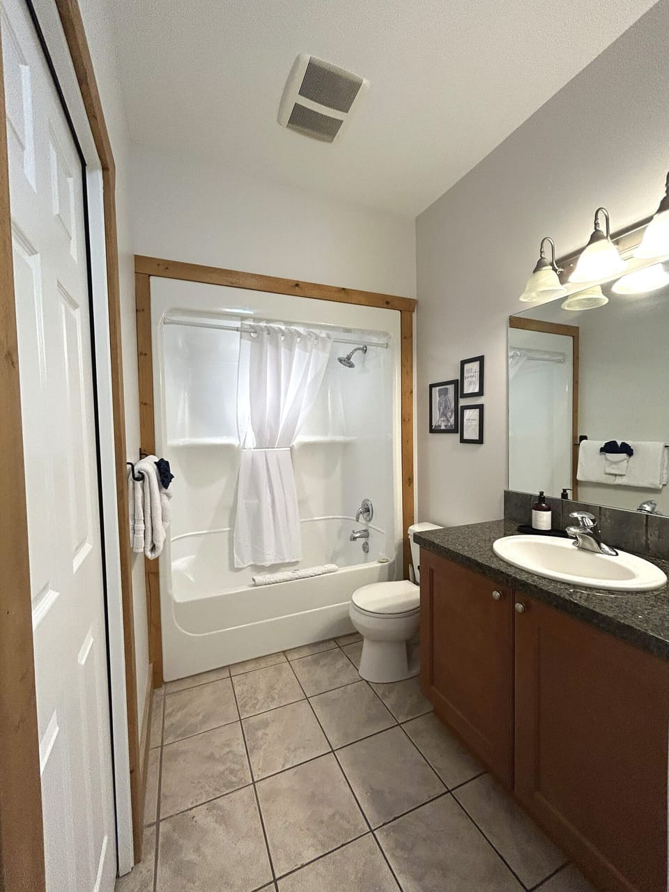 Elegant Ensuite Bathroom with Granite Countertop, Bathtub, Washer & Dryer	