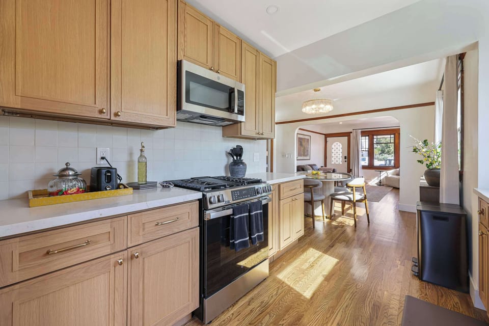 Cook with ease in this bright, modern kitchen featuring stainless steel appliances and ample counter space. Its open layout keeps you connected to the dining and living areas while you meal prep.