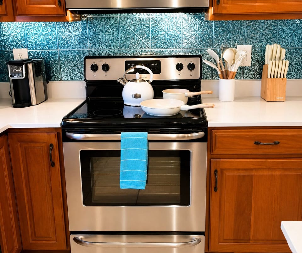 Kitchen visible, indoor, coffee and or coffee maker, kitchen, oven, stovetop.  Tea kettle and stocked pans and pots, toaster, and all the kitchen basics you could need. 