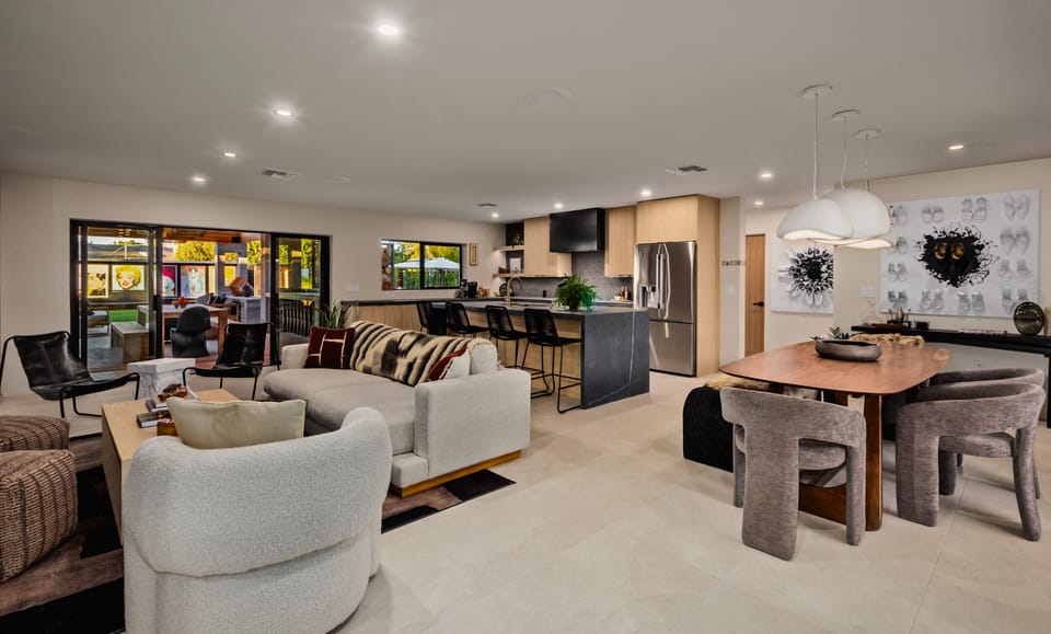 Your first look inside The Gallery. This open-concept living space blends modern design, curated artwork, and effortless indoor-outdoor flow — a stylish preview of the elevated comfort and Scottsdale charm waiting throughout the home.