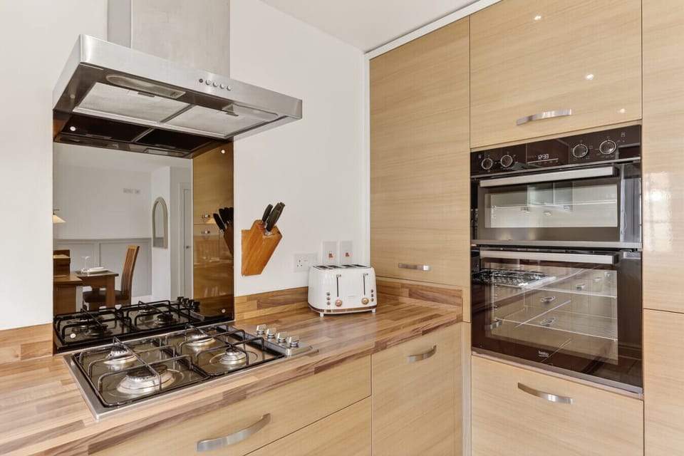 A modern, fully equipped kitchen offers all the essentials to cook and dine at your leisure.