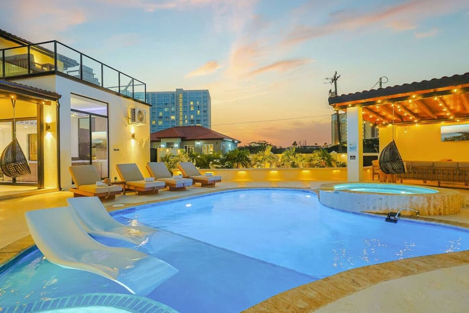 Luxury Poolside Evenings with Warm Lighting, Jacuzzi, and Lounge Area—Perfect for Relaxing Nights and Unforgettable Getaways
