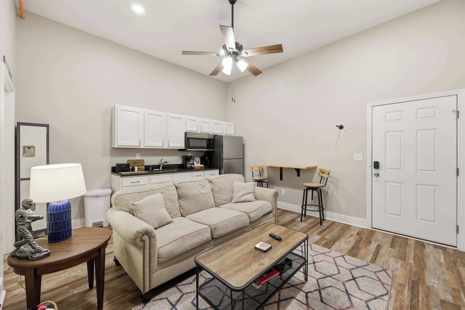 Living Area: Relax in this cozy living space with kitchenette, perfect for unwinding after exploring Churchill Downs and Louisville’s top eateries nearby.