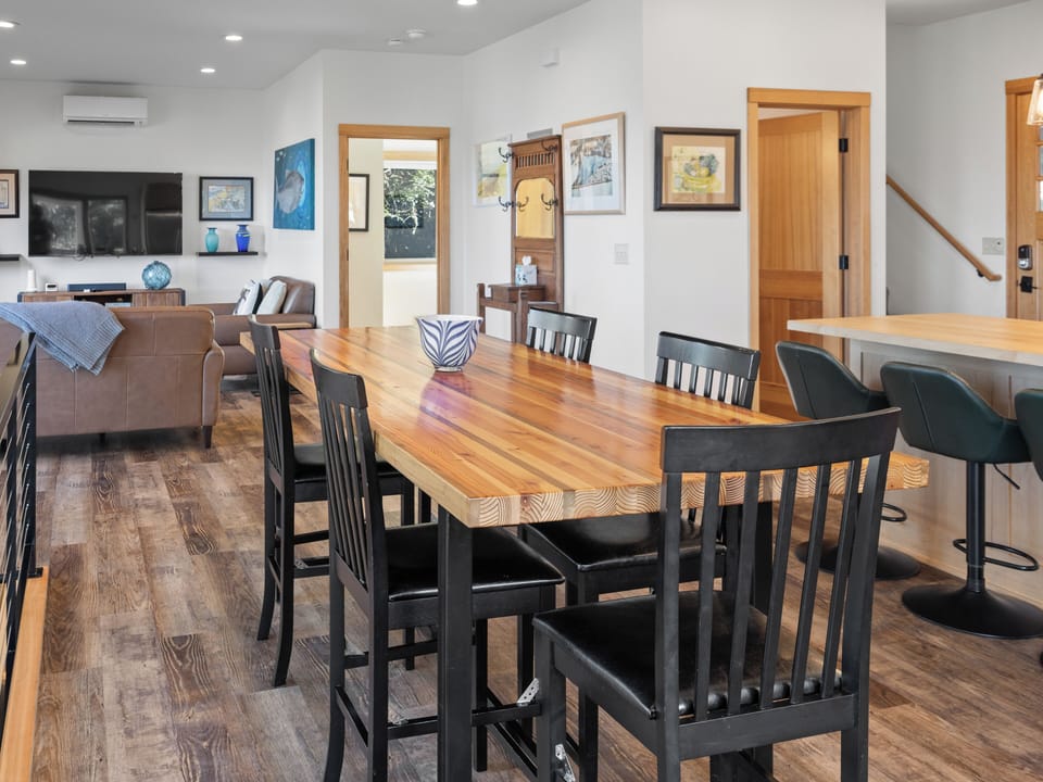 Your open-plan dining area flows seamlessly into the living space, featuring warm wood tones and modern comfort for memorable meals together.
