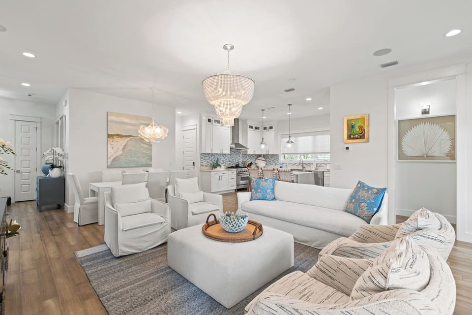 Sink into plush white seating and enjoy the open-concept elegance, where your living space flows seamlessly into a chef's kitchen.