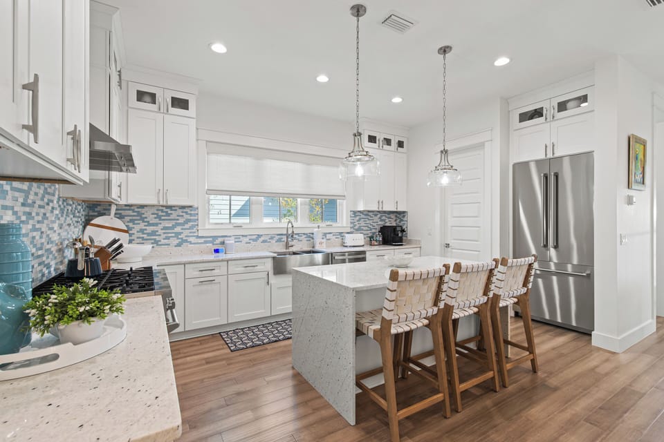 Your gourmet kitchen awaits with gleaming quartz countertops, modern appliances, and a spacious island perfect for morning coffee or evening gatherings.