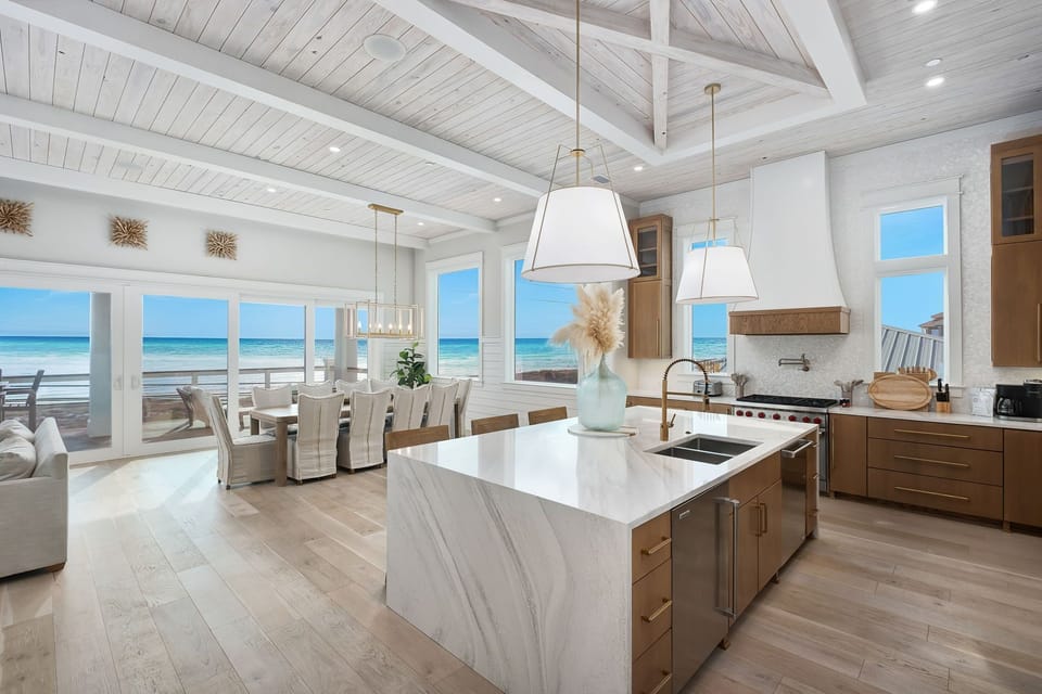 Cook with stunning gulf views through floor-to-ceiling windows in your dream beachfront kitchen.