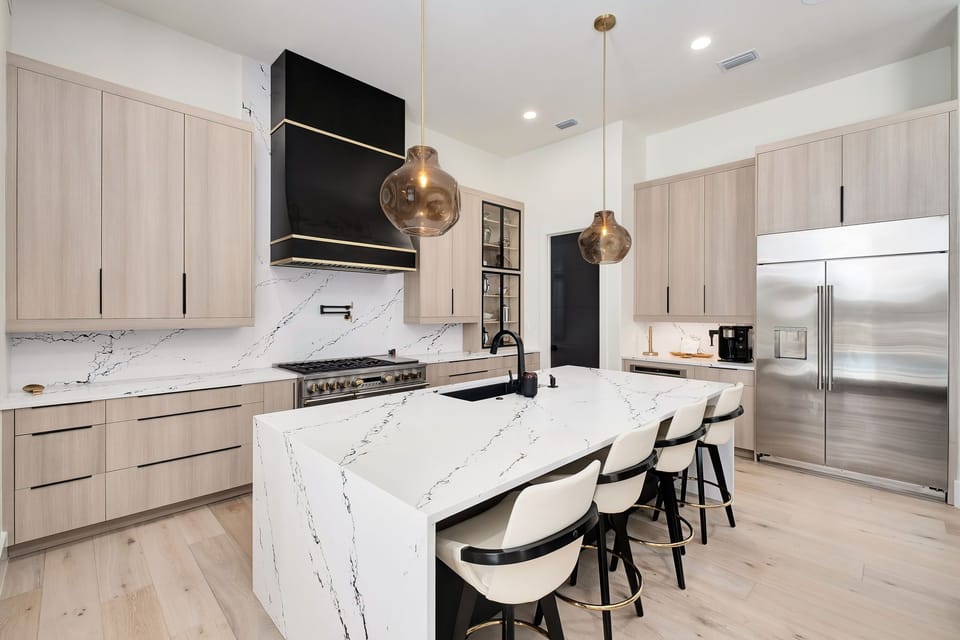 Your gourmet kitchen awaits with stunning marble countertops, premium appliances, and elegant pendant lighting for memorable meal preparation.