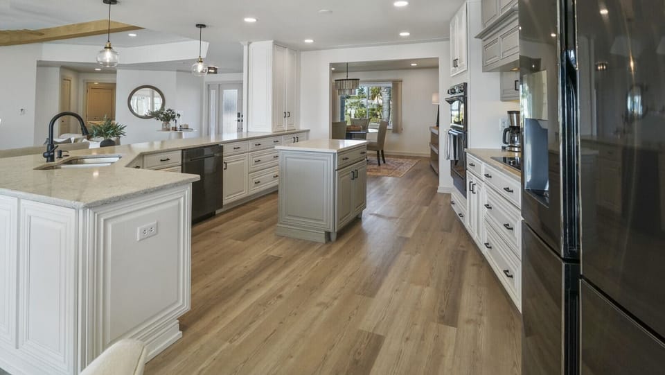 Gourmet kitchen with dual ovens, new stainless-steel Samsung appliances, and waterfront views