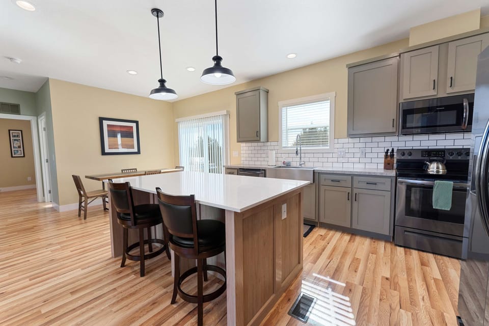 Fully stocked kitchen with oversized island and plenty of seating — ideal for group meals before hitting the trails.