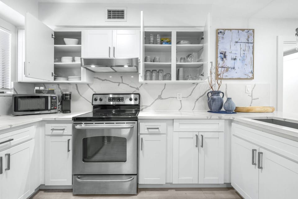 Well-stocked cabinets with dishes, glassware, and essentials — everything you need to feel right at home.