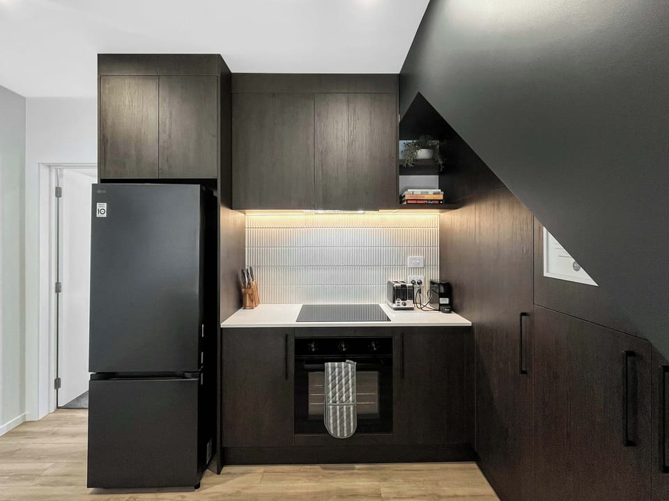 Sleek modern kitchen with quality appliances and under-cabinet lighting
