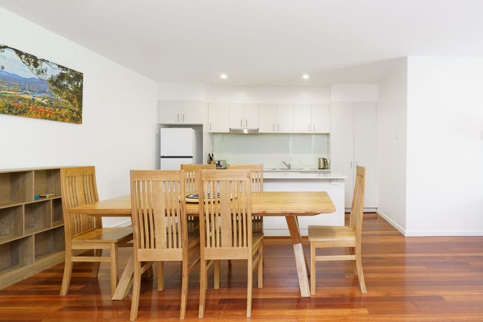 Warm dining space with wooden furniture, creating a welcoming spot to gather and enjoy meals.