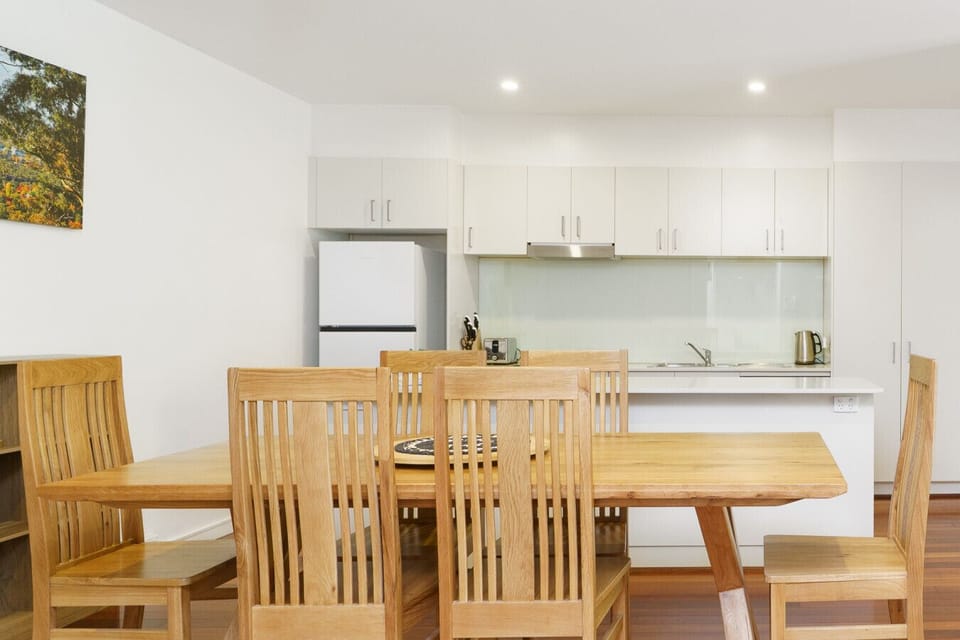 Warm dining space with wooden furniture, creating a welcoming spot to gather and enjoy meals.