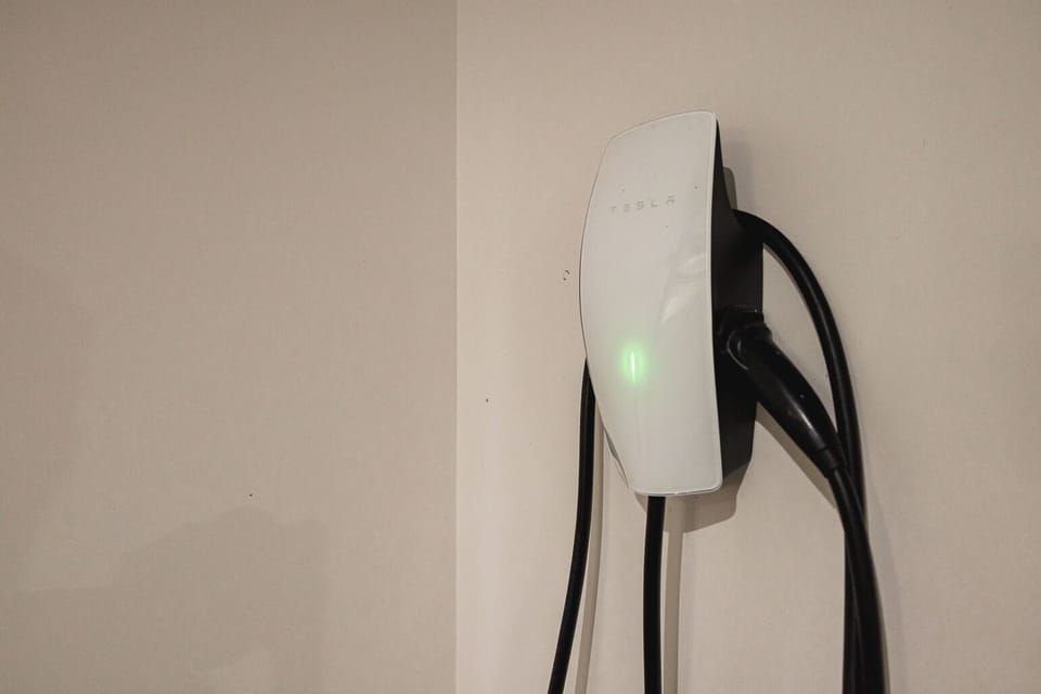 Electric charger for car located in the closed garage.