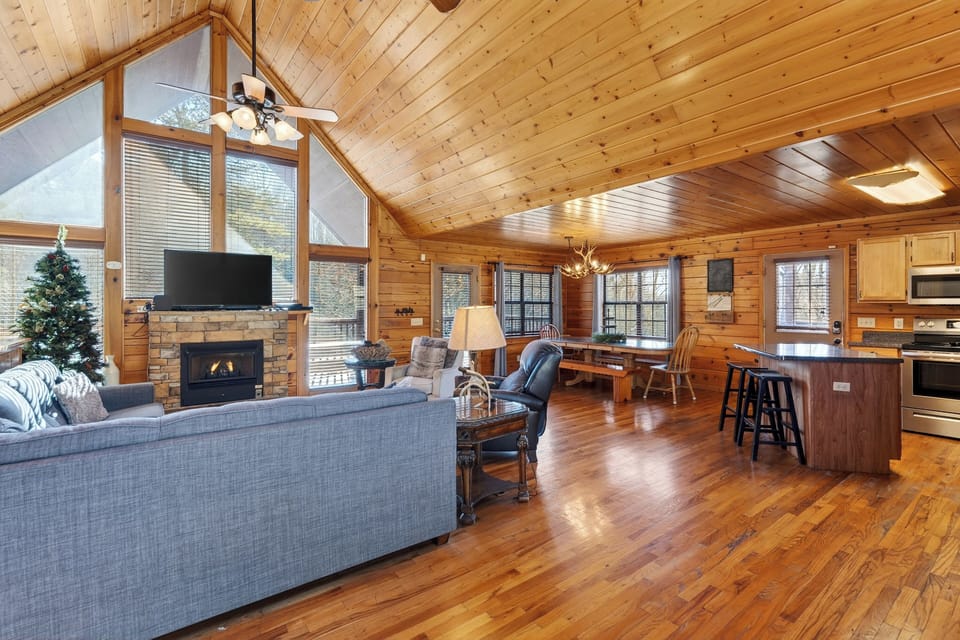 View from the living room toward the dining area and kitchen, showcasing the all-wood interior.