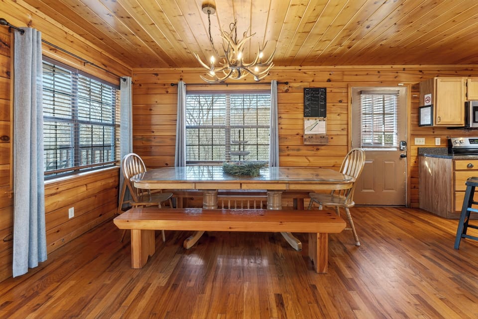 Rustic wooden dining table with bench seating, ideal for family meals.