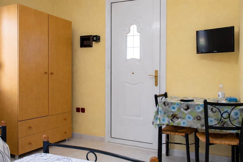 Sleeping area with wardrobe space and in-room TV.