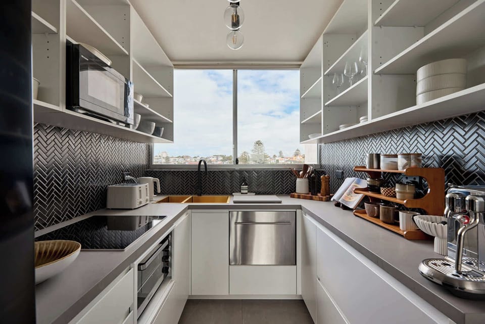Modern gourmet kitchen with sleek finishes, open shelving, and stunning natural light.