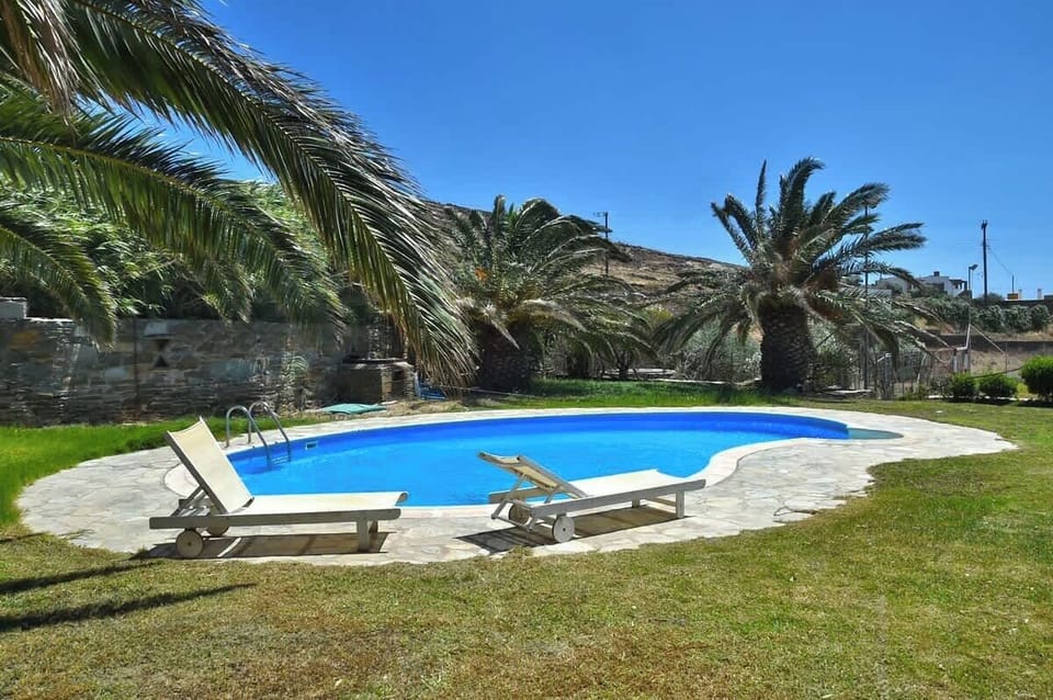 Poolside Lounge Area with Sunbeds and Garden Views