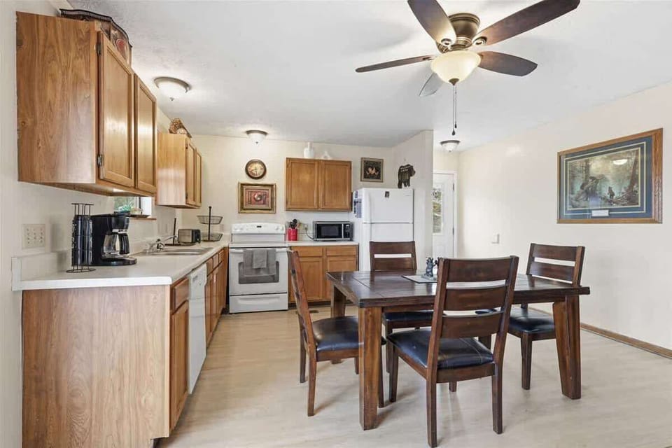 You'll love preparing meals in your fully equipped kitchen with warm wood cabinets, then gathering at the dining table for memorable conversations.